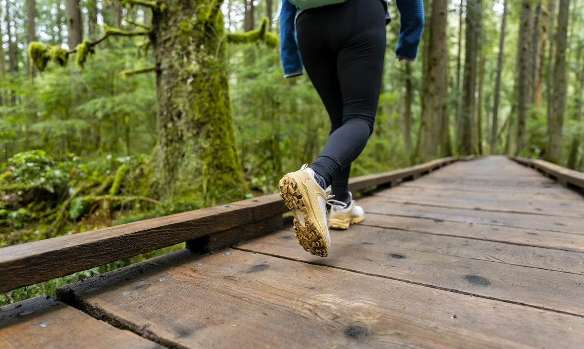 Woman walking through a forest in Oboz Katabatic low hiking shoes.