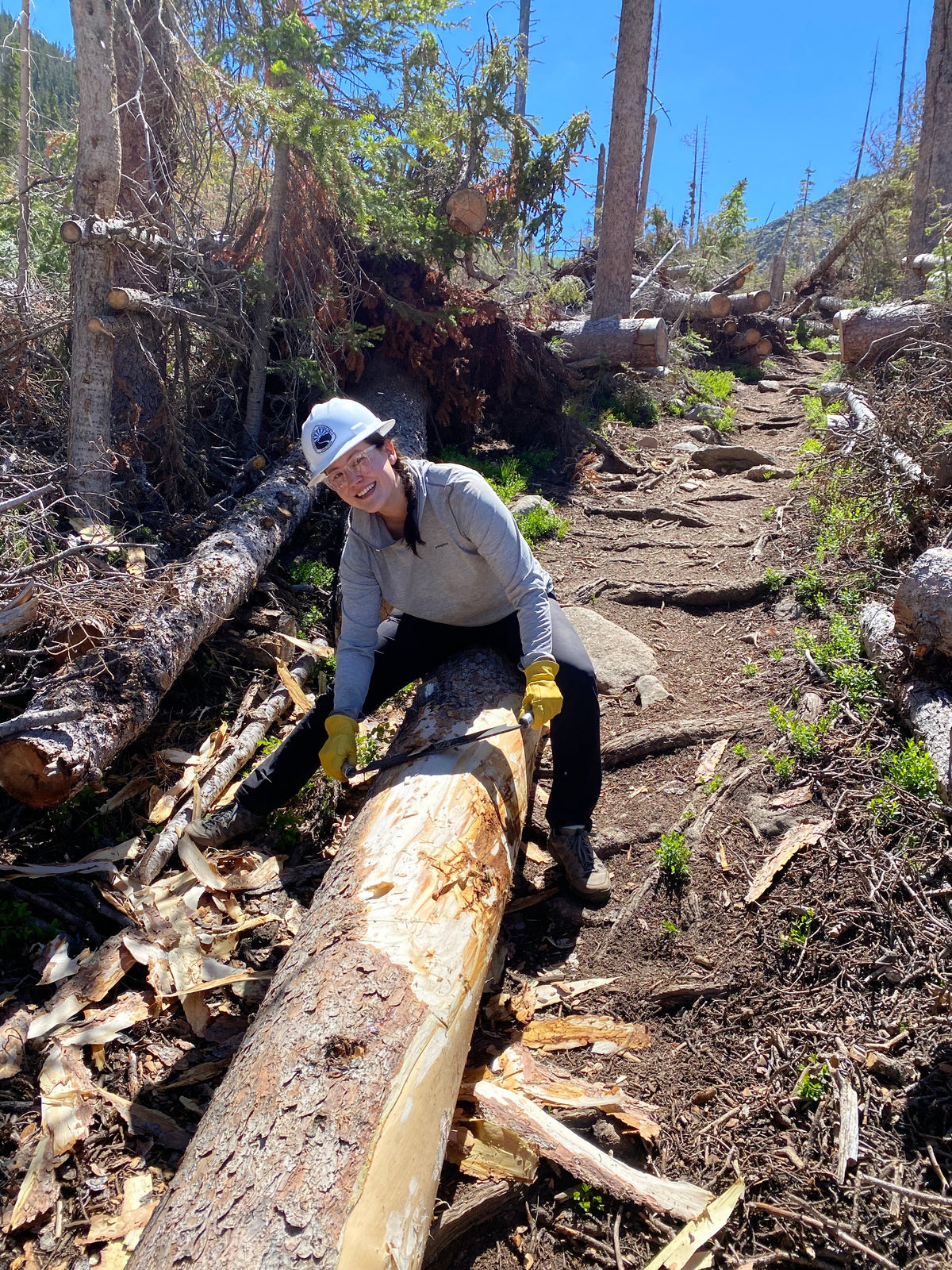 Woman doing trail maintenance in Oboz Sawtooth X Low hiking shoes. 