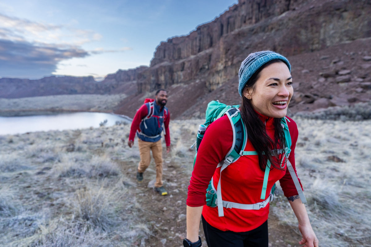Two people hiking through the desert in Oboz hiking shoes.