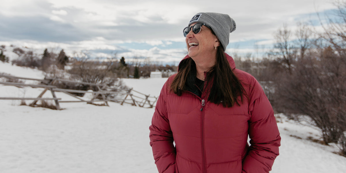 Oboz President Amy Beck smiling on a local Bozeman trail during the wintertime