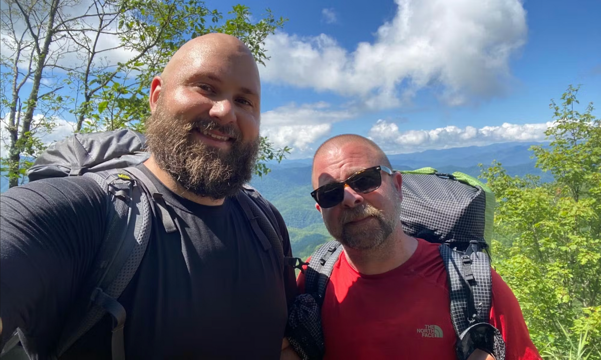 Two individuals backpacking the Smokies on a bright and sunny day
