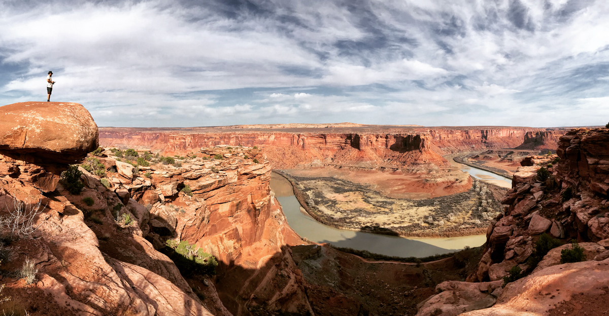 Alexi Kimiatek overlooking a river flowing through the canyon