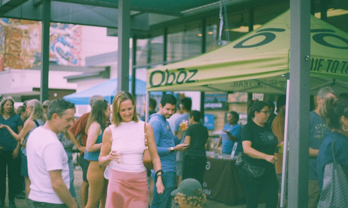 Shoppers gather outside an Oboz tent at Whole Earth Provision Co. 