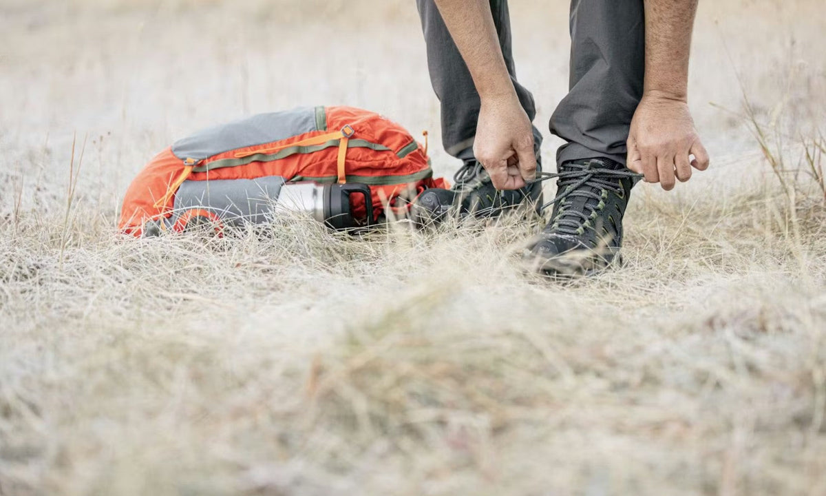 Oboz Sawtooth shoe being tied while on a hiking trip. 