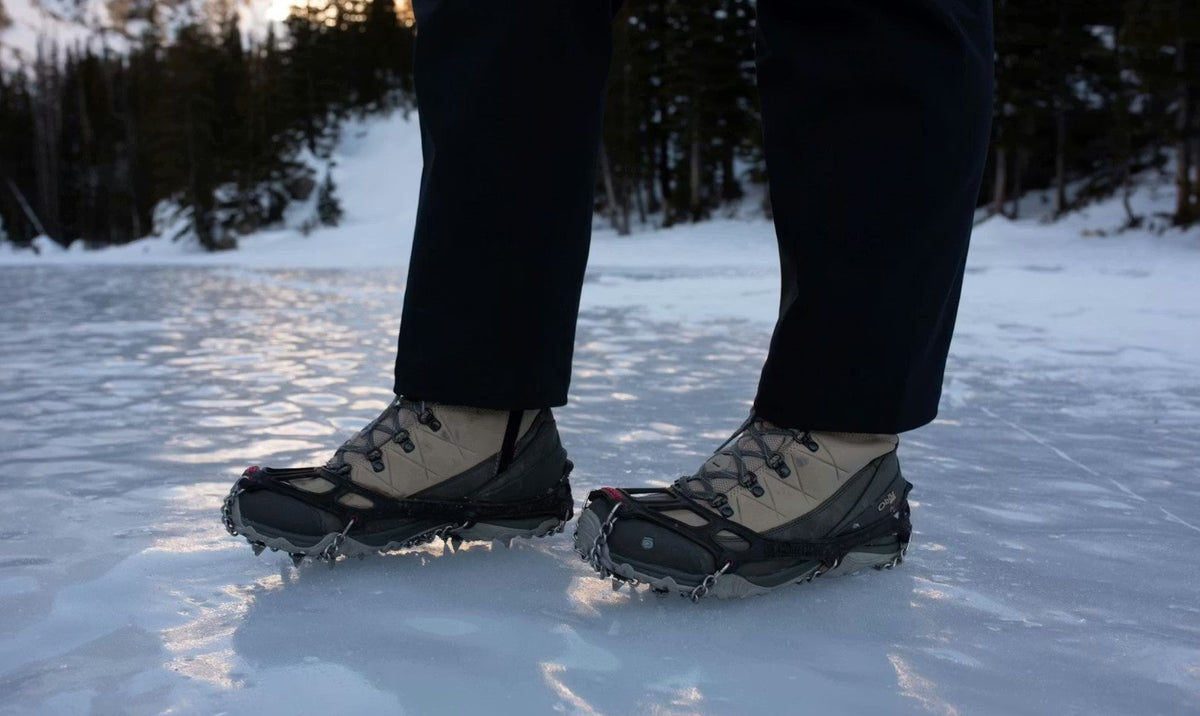 Oboz Ousel hiking shoes with microspikes for traction on an icy hike.