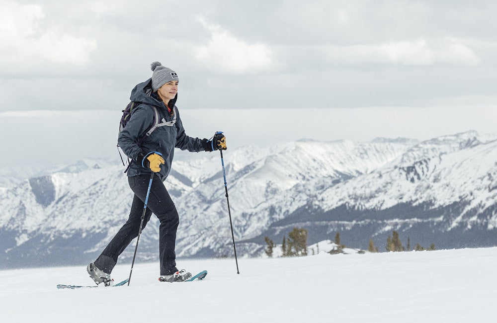 Person snowshoeing on a cloudy winter day.