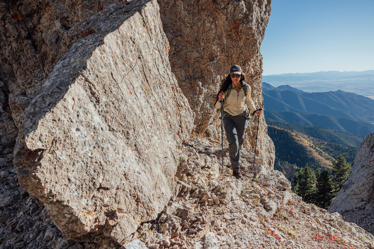 Person hiking on a rocky mountain trail wearing Oboz Bridger Peak
