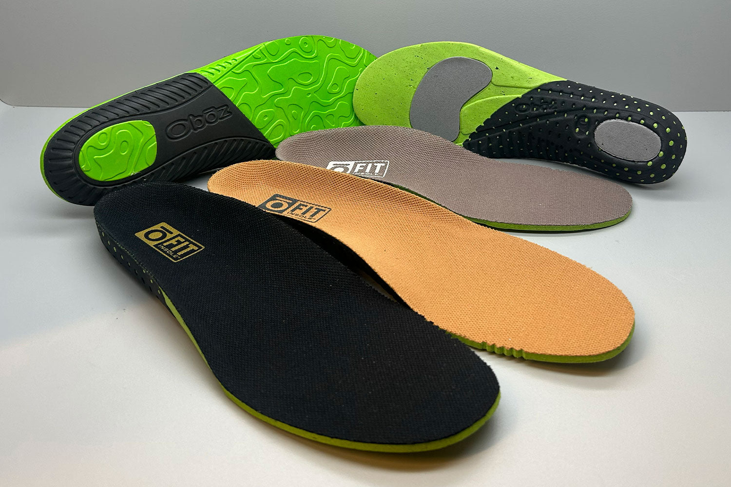 Boz O Fit shoe insoles on a white surface with a gray background.
