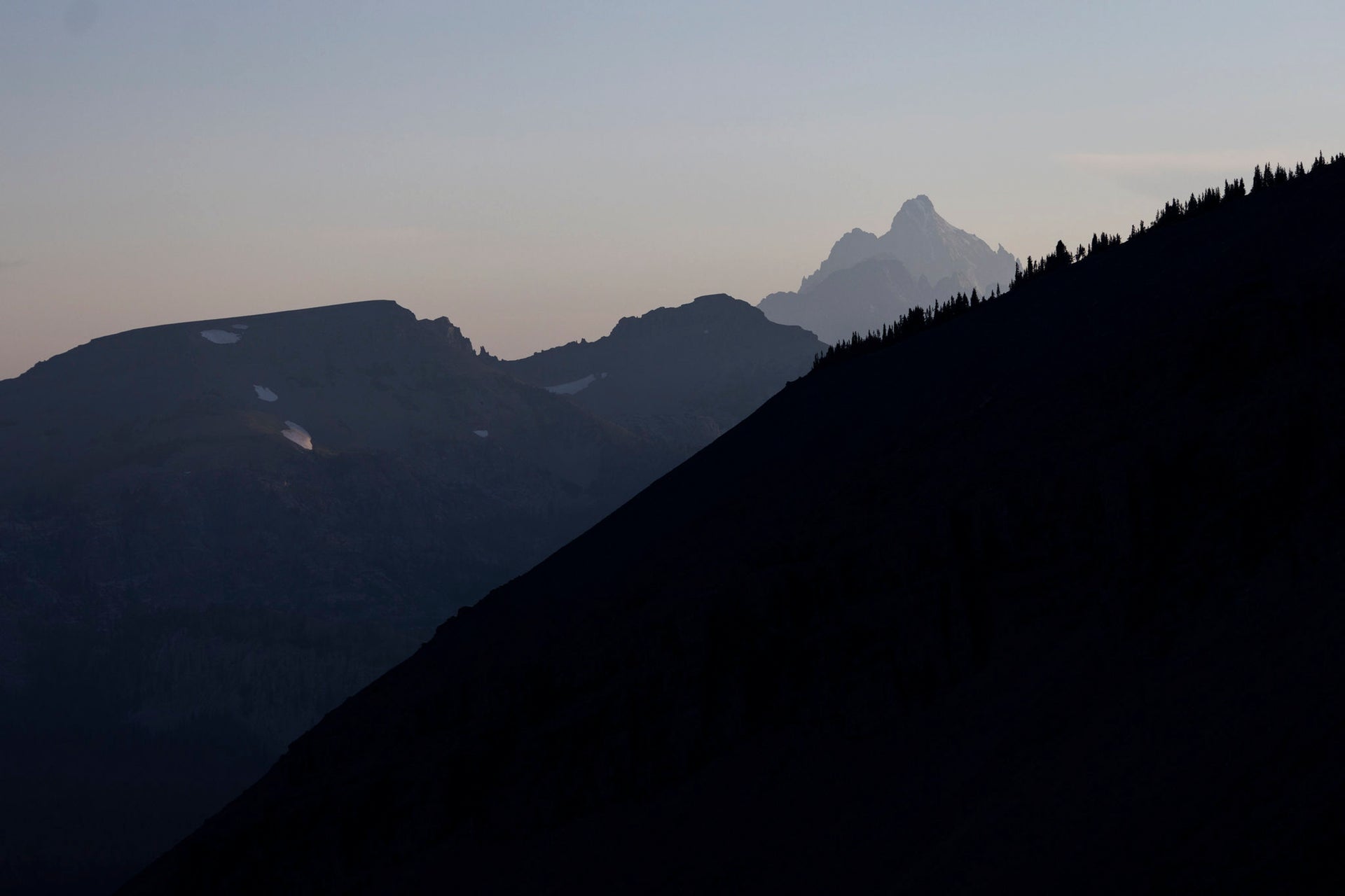 Silhouette of mountains against a dark sky
