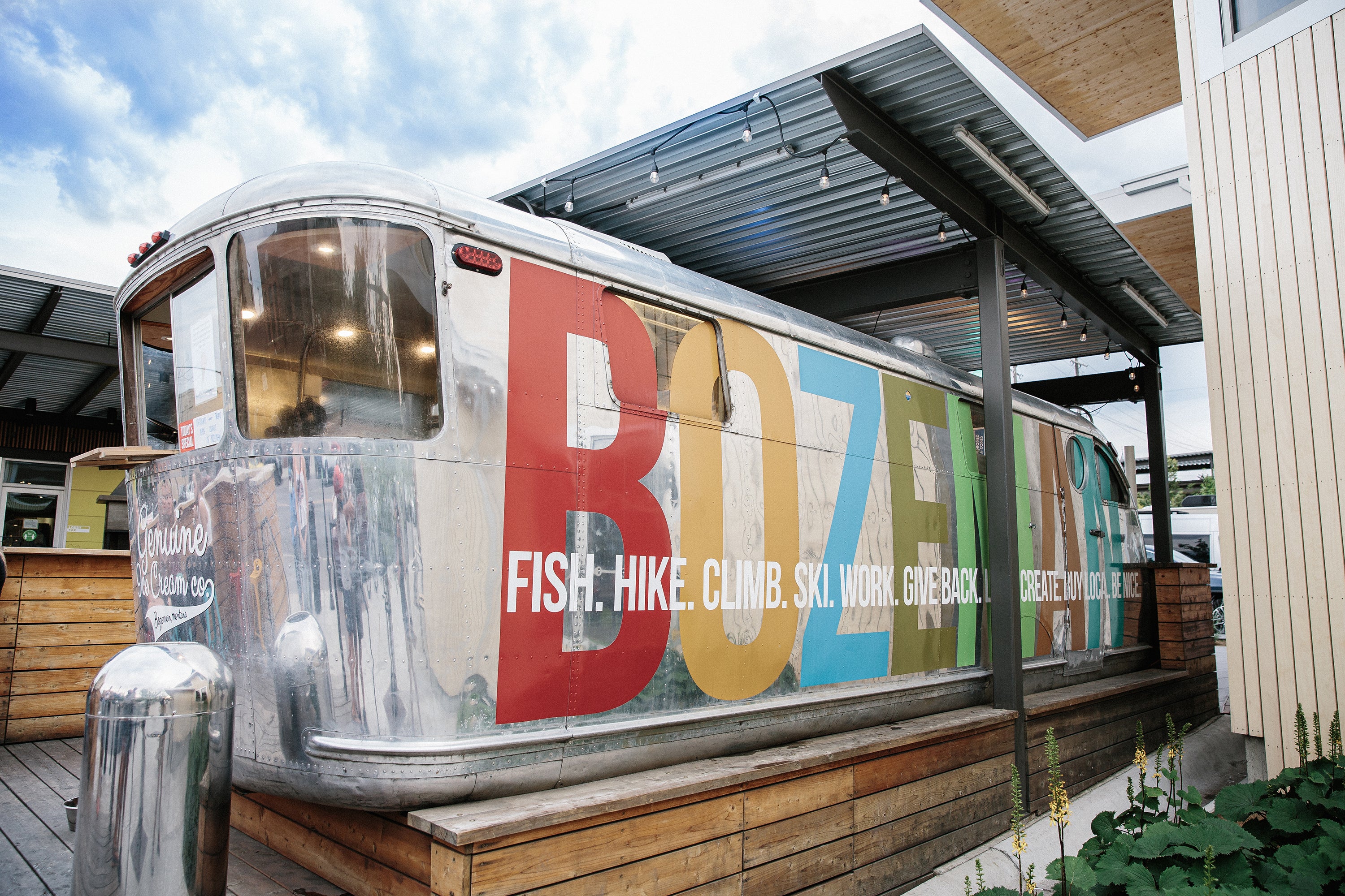 Colorful ice cream trailer with 'BOZEMAN' branding and outdoor setting