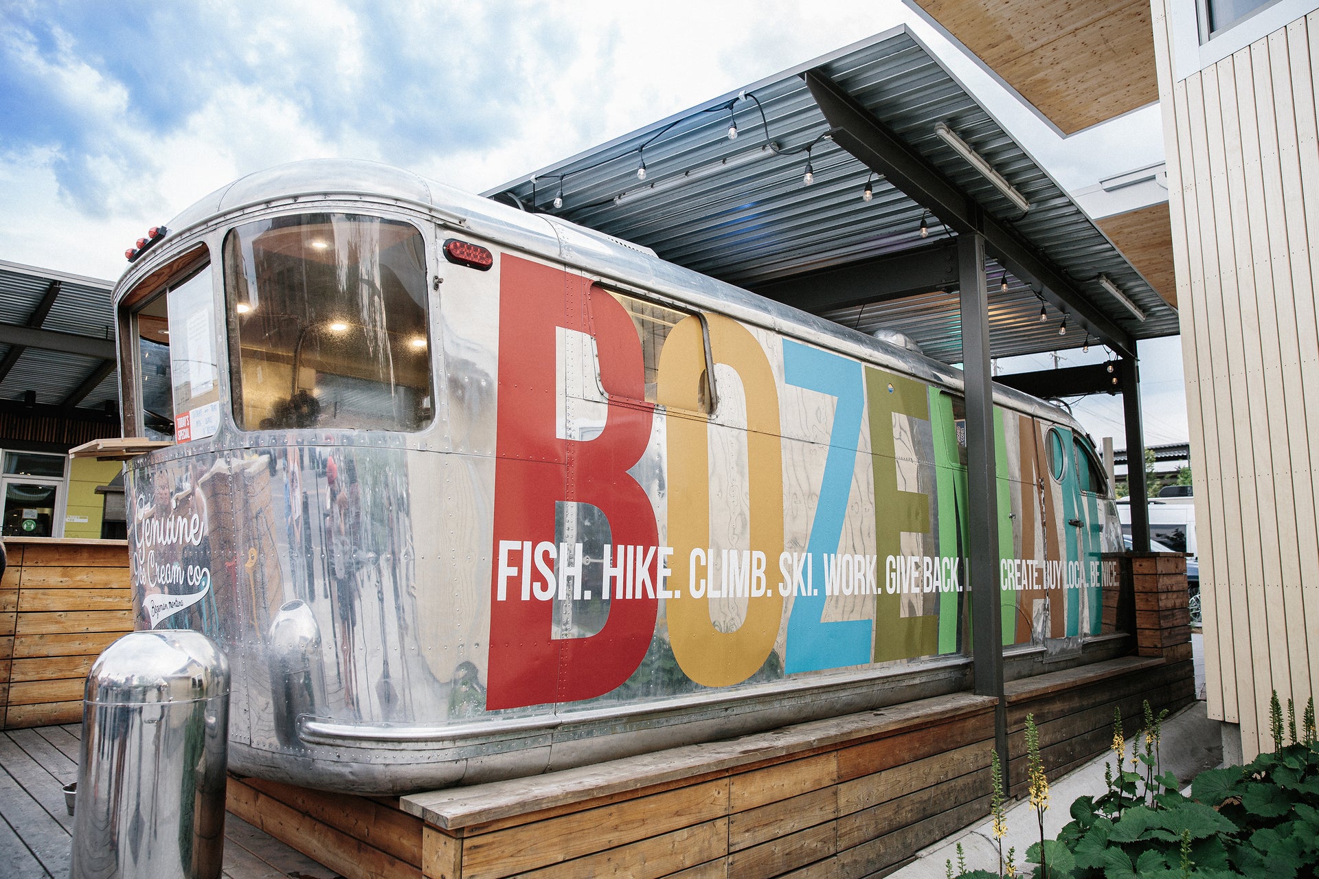 Colorful ice cream trailer with 'BOZEMAN' branding and outdoor setting