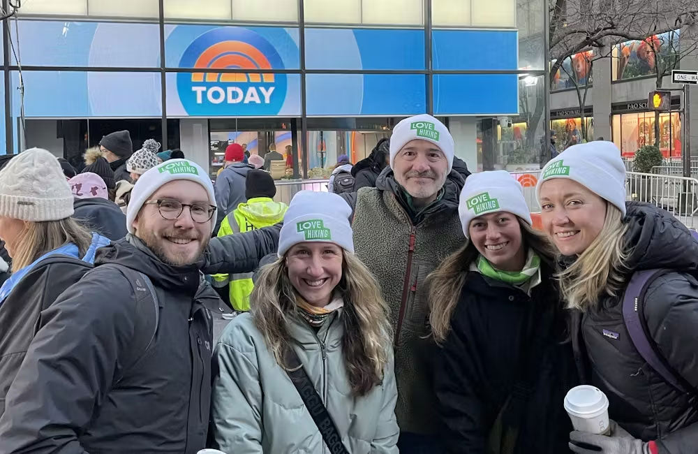 Group of people wearing 'Oboz' branded hats in front of a building with the 'Today' logo.