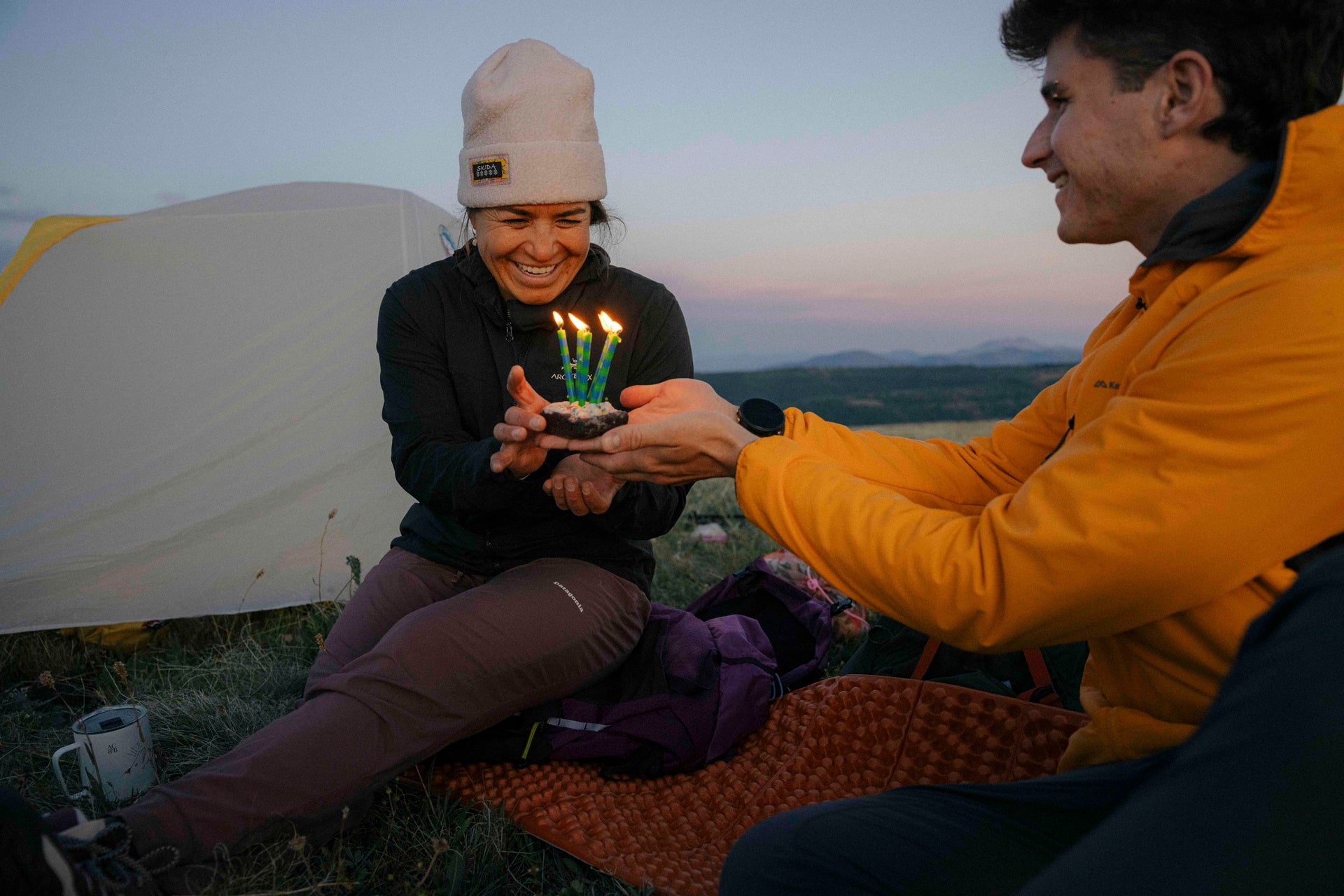 Two people celebrate a birthday in the backcountry while at camp.